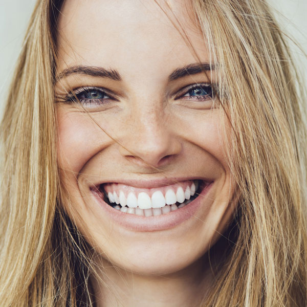 Smiling woman after cosmetic dentistry treatment in Monroeville, PA