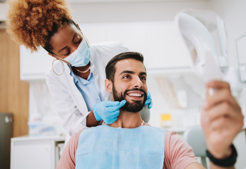 A patient smiling during a dental sealant check, highlighting dental care in Monroeville, PA