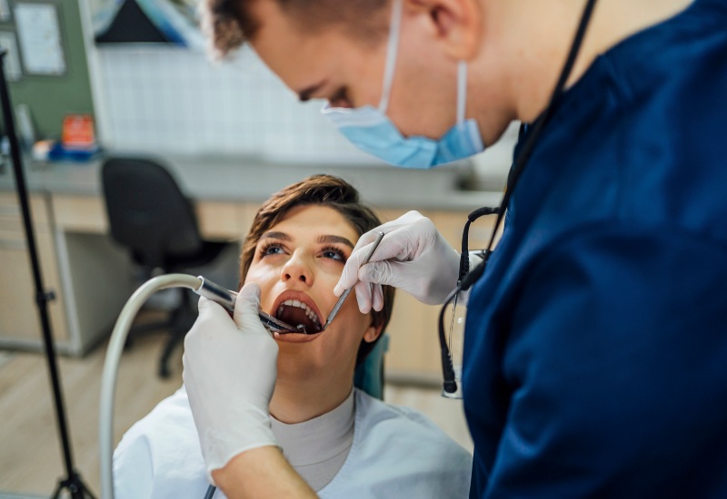 A dentist performing root canal treatment on a patient in a dental clinic in Monroeville, PA